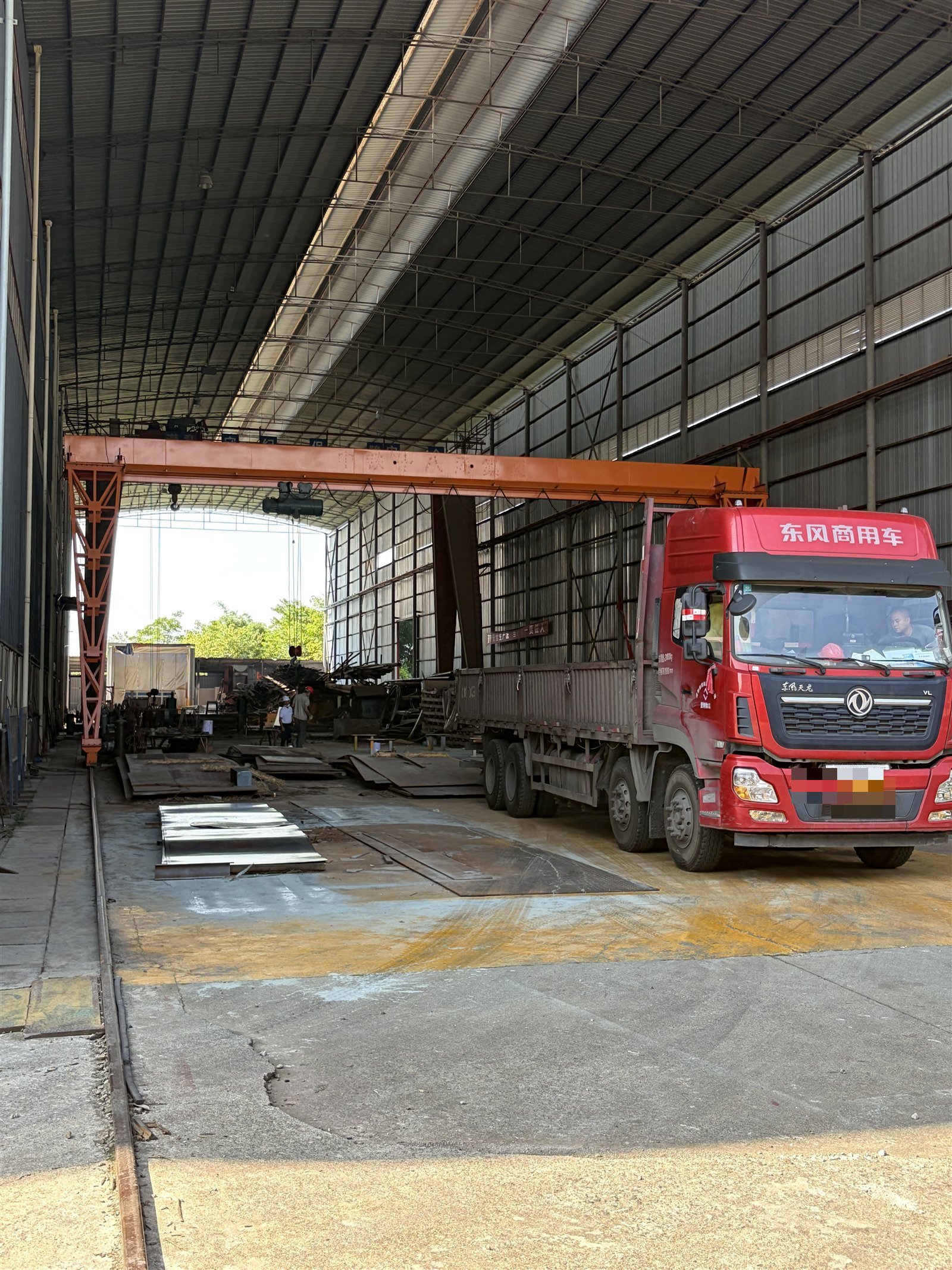 Container truck loading at the factory dispatch yard under the gantry crane