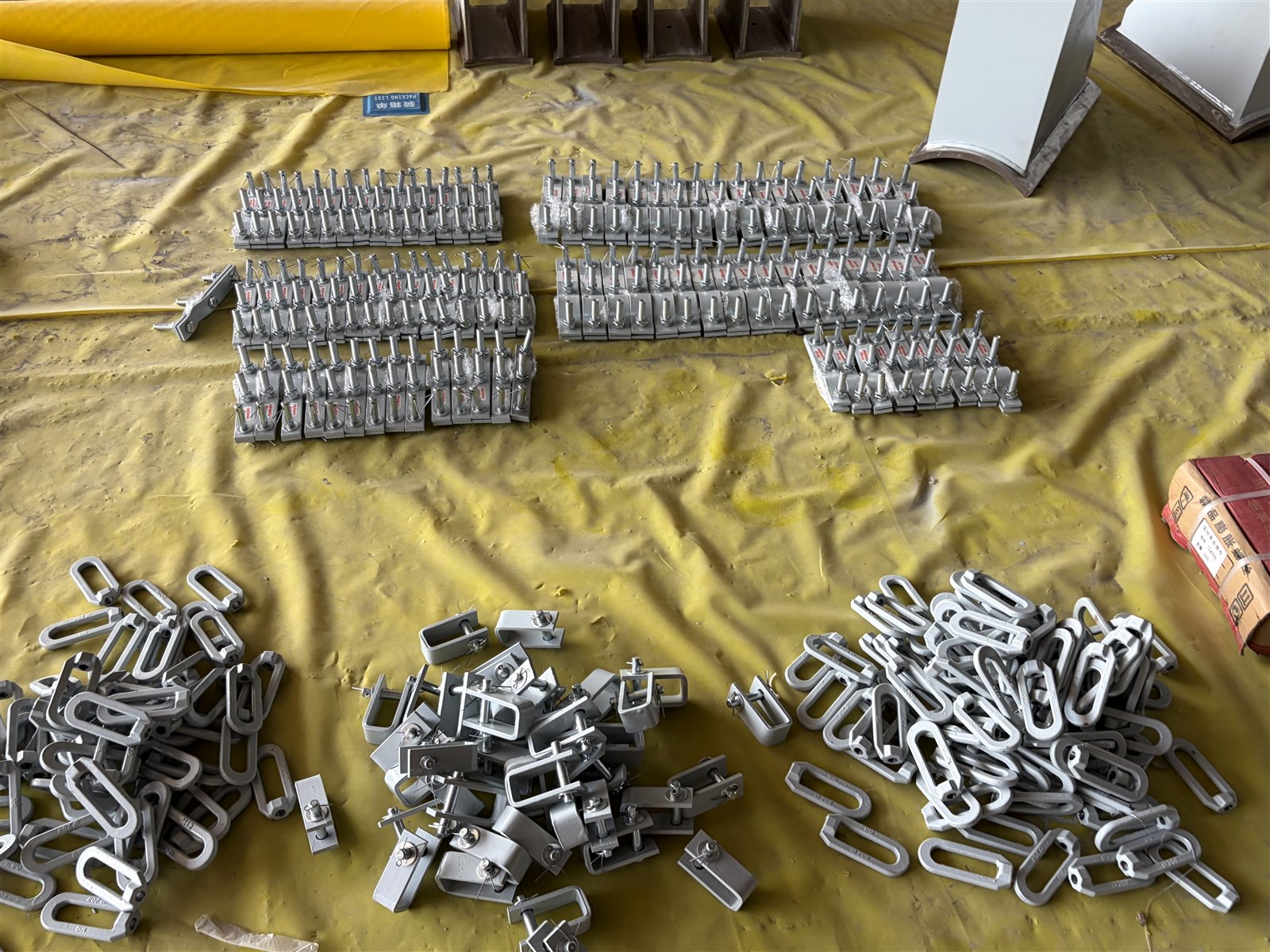 Forged lifting eyes, beam clamps and tagged hanger hardware in factory stock