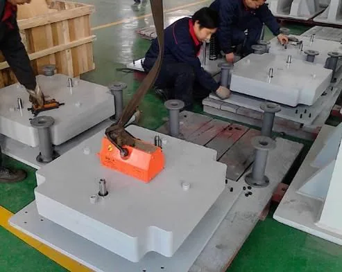 Factory workers assembling large fabricated support equipment