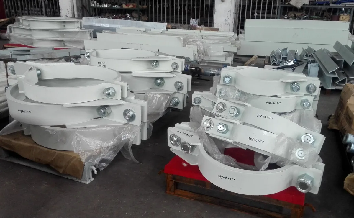 Fabricated pipe clamp assemblies arranged on factory pallets